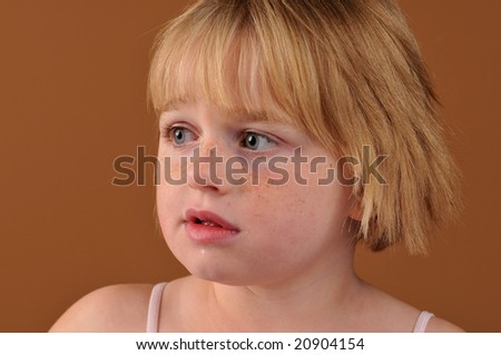 Special needs girl isolated against a brown background