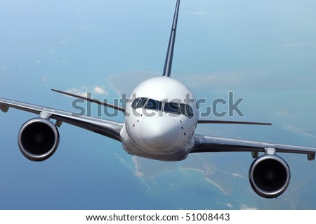 Airliner in flight with ocean and islands on the background