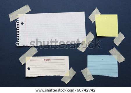 Notes with masking tape on a blue board