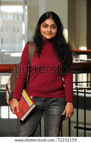 Young Eastern Woman Holding a Book inside a College Building