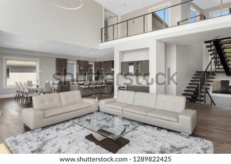 Living Room and Kitchen in New Luxury Home. Features Open Concept Floor Plan.