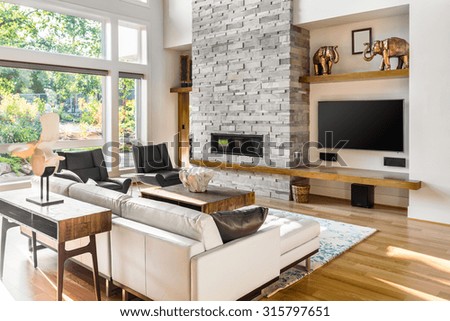 Beautiful living room with hardwood floors and fireplace in new luxury home. Focus is on Foreground