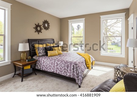 Furnished master bedroom interior in new home with colorful furnishings