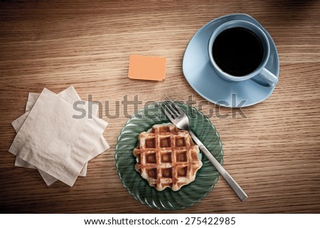 Space for your coffee shop\'s or restaurant\'s logo or message on napkins next to coffee and a snack.