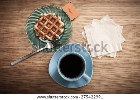 Space for your coffee shop's or restaurant's logo or message on napkins next to coffee and a snack.