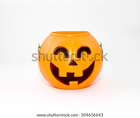 A studio isolated Jack O'lantern container used for collecting candy on Halloween.