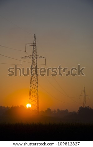summer sunrise landscape with sun and utility pole