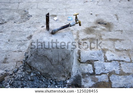 old and dirty water tap in Jaipur street, India