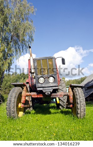 ancient agriculture tractor in farm garden