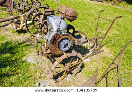 ancient rusted agriculture tools collection in farm garden