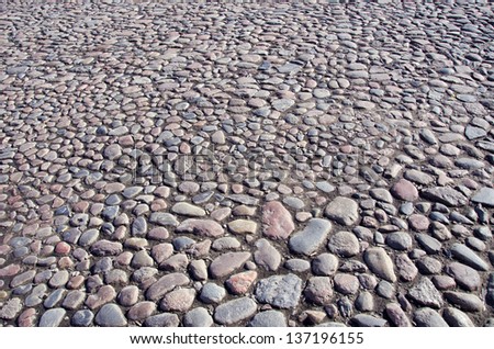 natural cobblestone sidewalk in city square background and texture