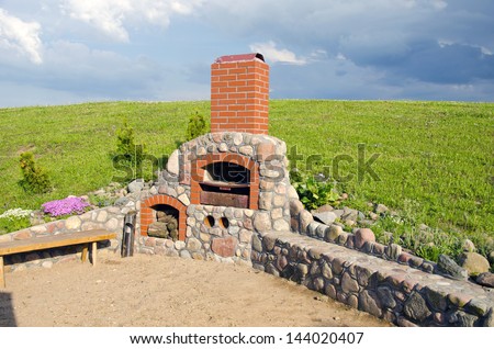 summer outdoor fireplace in garden construction