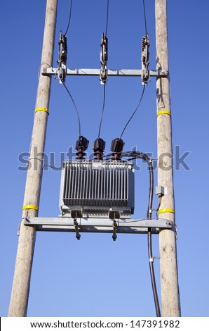 Wooden Utility Pole with Power Lines and transformer on sky background