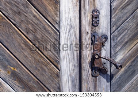 old wooden door fragment with metal craft handle