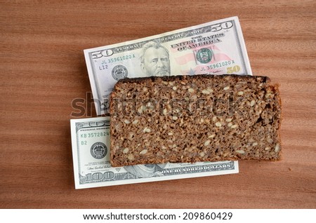 brown bread food and money concept. Healthy vegetarian bread and usd dollar banknote