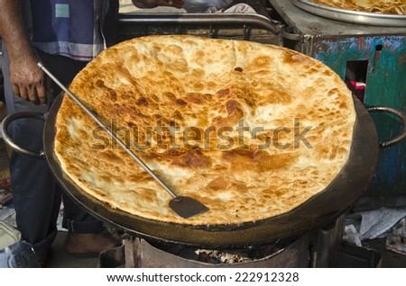 big pancake chapati bread in Mumbai Bombay market, India