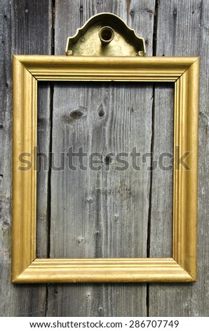 vintage empty golden wooden picture frame on old wooden wall background