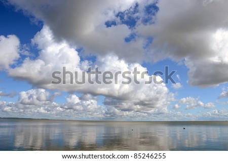 summer end seascape with clouds reflections