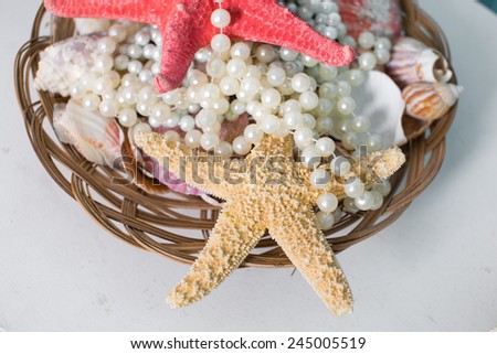 Beautiful starfish and pearl beads in a basket