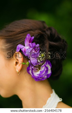Beautiful bride with beautiful hairstyle vivid purple flowers, wedding