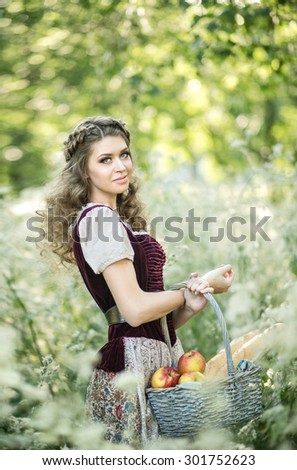 Beautiful girl in a simple dress on the background of the rural nature, summer, sunset