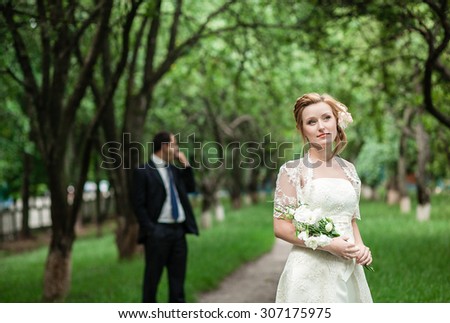 The bride and groom in a shady alley apple orchard, wedding day