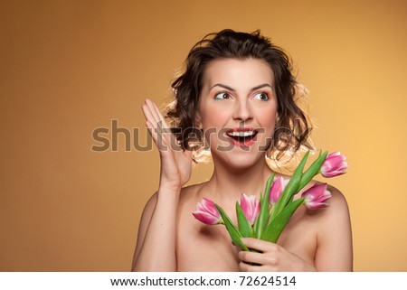 Portrait of a beautiful girl with a bouquet of tulips and wow emotion.