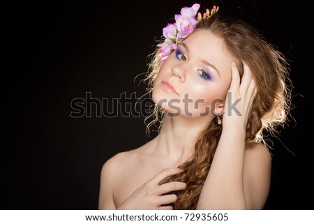 Glamorous portrait of a beautiful girl with lush hair.