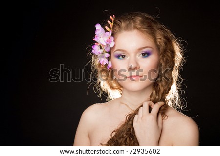 Glamorous portrait of a beautiful girl with lush hair.