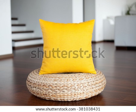 Yellow  pillow in white interior. Decorative yellow pillow in interior as bright accent.