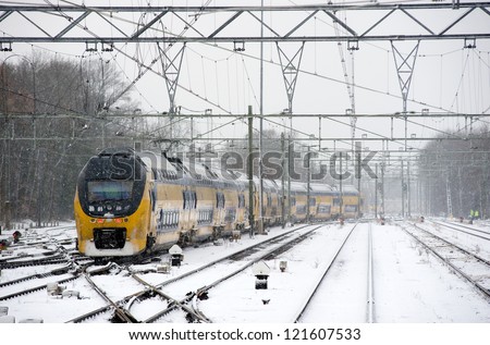 A train is arriving on a snow covered train station in the winter