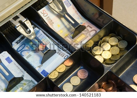 Cash money in drawer at a pay desk in a store