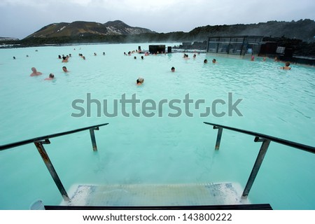 BLUE LAGOON, ICELAND - MAR 08: People bathing in The Blue Lagoon, a geothermal bath resort in the south of Iceland, a \'must see\' by tourists. March 08, 2013 in Iceland.