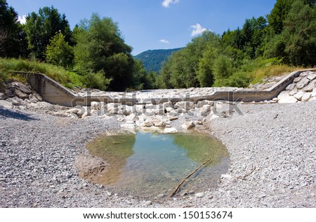 A pond is al that is left in the dry riverbed of the Zinkenbach river in the summer who ends in the Wolfgangsee in Austria
