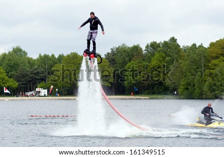 ENSCHEDE, NETHERLANDS - MAY 12: A man is giving a show how to keep in balance, and shows what you can do with the new sensation called flyboarding, May 12, 2013 in the Netherlands.