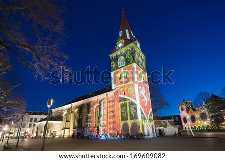 ENSCHEDE, NETHERLANDS - DEC 20: In the Dutch city Enschede the two main churches are being lighted by a beam with color effects because of Christmas for a week , December 20, 2013 in the Netherlands