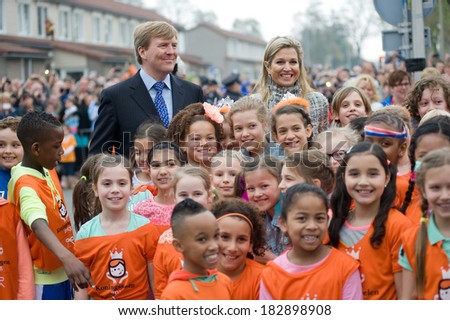 ENSCHEDE, NETHERLANDS - APR 26: Royal Highness Queen Maxima and King Willem Alexander between schoolkids after they just opened the \'koningsspelen\' on a school, April 26, 2013 in the Netherlands