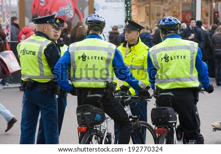 ENSCHEDE, NETHERLANDS - DEC 20: Five policemen are talking with each other during surveillance in the center of the city of Enschede, december 20, 2012 in the Netherlands