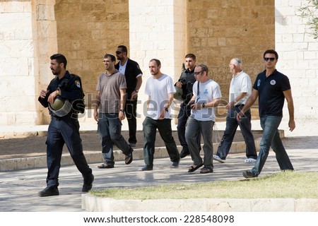 JERUSALEM, ISRAEL - OCT 08: Jews protected by security officers are walking on the temple-square and want to pray, this is the reason of the violence with muslims , October 08, 2014 in Israel