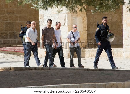 JERUSALEM, ISRAEL - OCT 08: Jews protected by security officers are walking on the temple-square and want to pray, this is the reason of the violence with muslims , October 08, 2014 in Israel