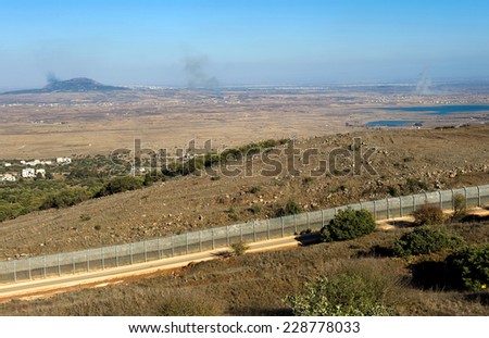 Explosions from the war in Syria can be seen from a hill on the Golan Heights 150 meter from the border, about 10 kilometers south/south-east of the city of Al Quneitra, October 04, 2014 in Israel