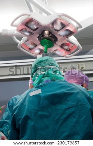 A surgeon in protective clothes during an operation in a hospital