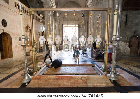 JERUSALEM, ISRAEL - OCT 06, 2014: The stone of the Anointing at the Church of the Holy Sepulchre. Also known as \'The Stone of Unction\', on this place Jesus\' body was prepared for burial.