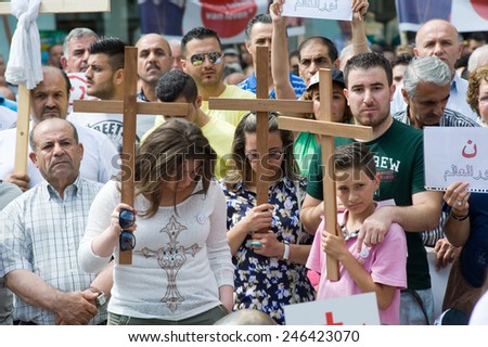 ENSCHEDE, NETHERLANDS - AUG 03, 2014: During a demonstration organized by suryoye christians against the slaughter of christians in the middle east there is a minut of silence for those who are dead