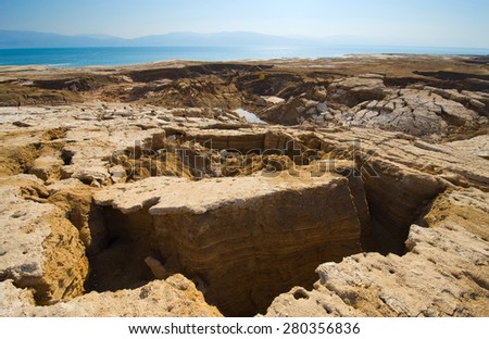 Sinkholes or open pit on the shore\'s of the dead sea at the end of the summer when the water level is at it\'s lowest