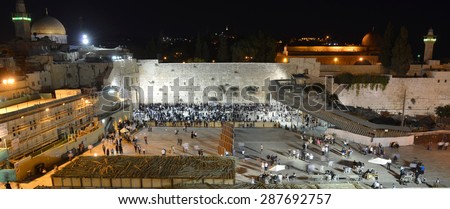 JERUSALEM, ISRAEL - OCT 09, 2014: Jewish people are praying in the evening in front of the western wall in the old city of Jerusalem