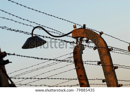 Fence, wire and a lamp in Auschwitz Birkenau