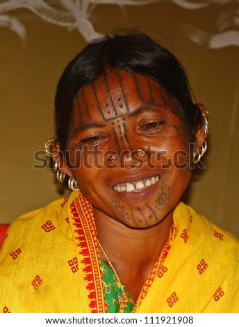 ORISSA, INDIA - JANUARY 30: An Indian lady with authentic tribal tattoo, painted on her face, visits annual tribal fair on January 30, 2011 at Orissa, India.