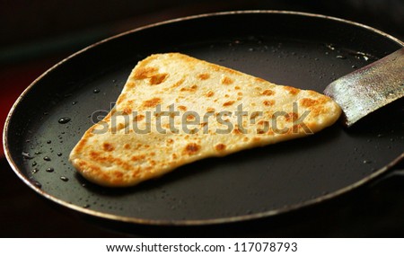 Freshly frying paratha with refined oil on pan