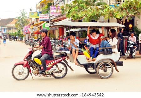 CAMBODIA - NOVEMBER 17: People ride tuktuk, the most popular public transport of Cambodia on November 17, 2013 in Cambodia